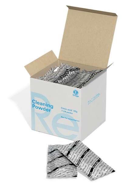 A white box labeled Cleaning Powder with several individual sachets inside and two sachets placed in front of the box. The box has blue text and a partially visible logo.